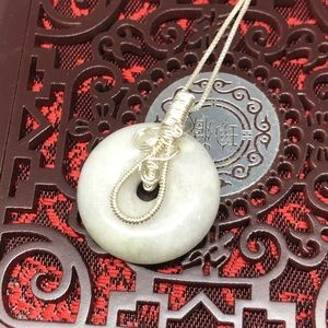 White jade pendant on handmade silver wire warp